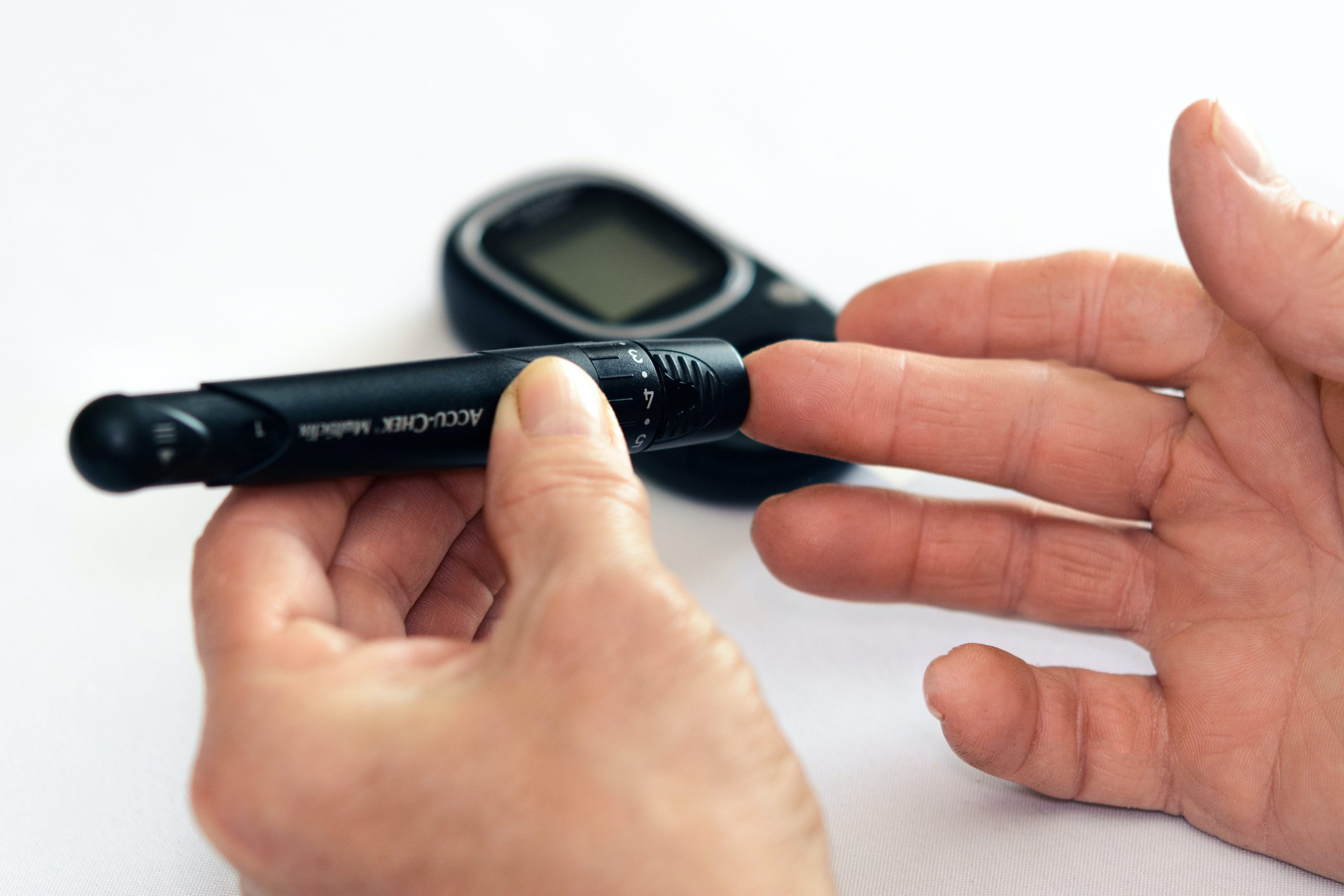 person holding a black blood sugar testing kit