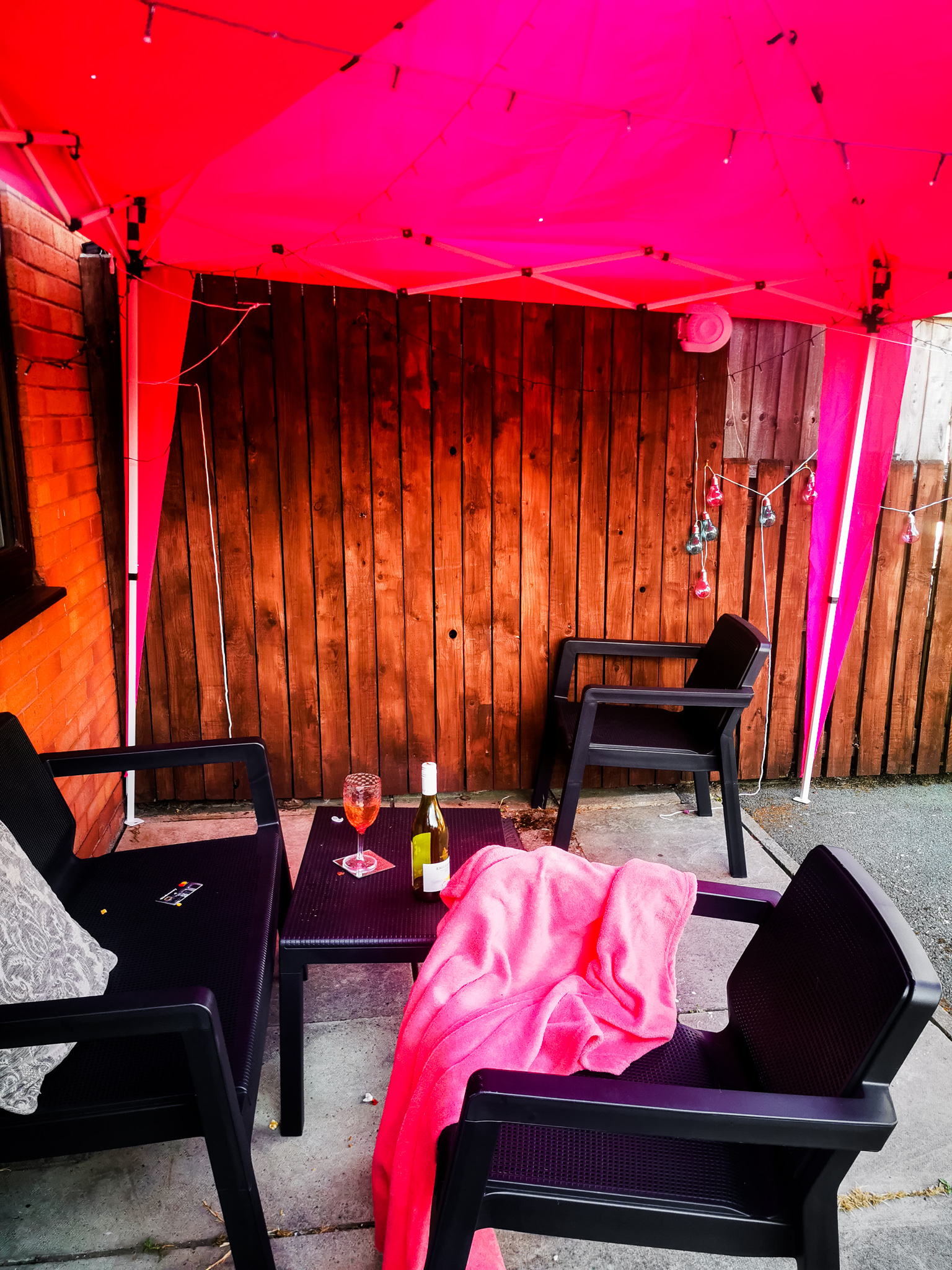 hot pink gazebo with garden furniture underneath