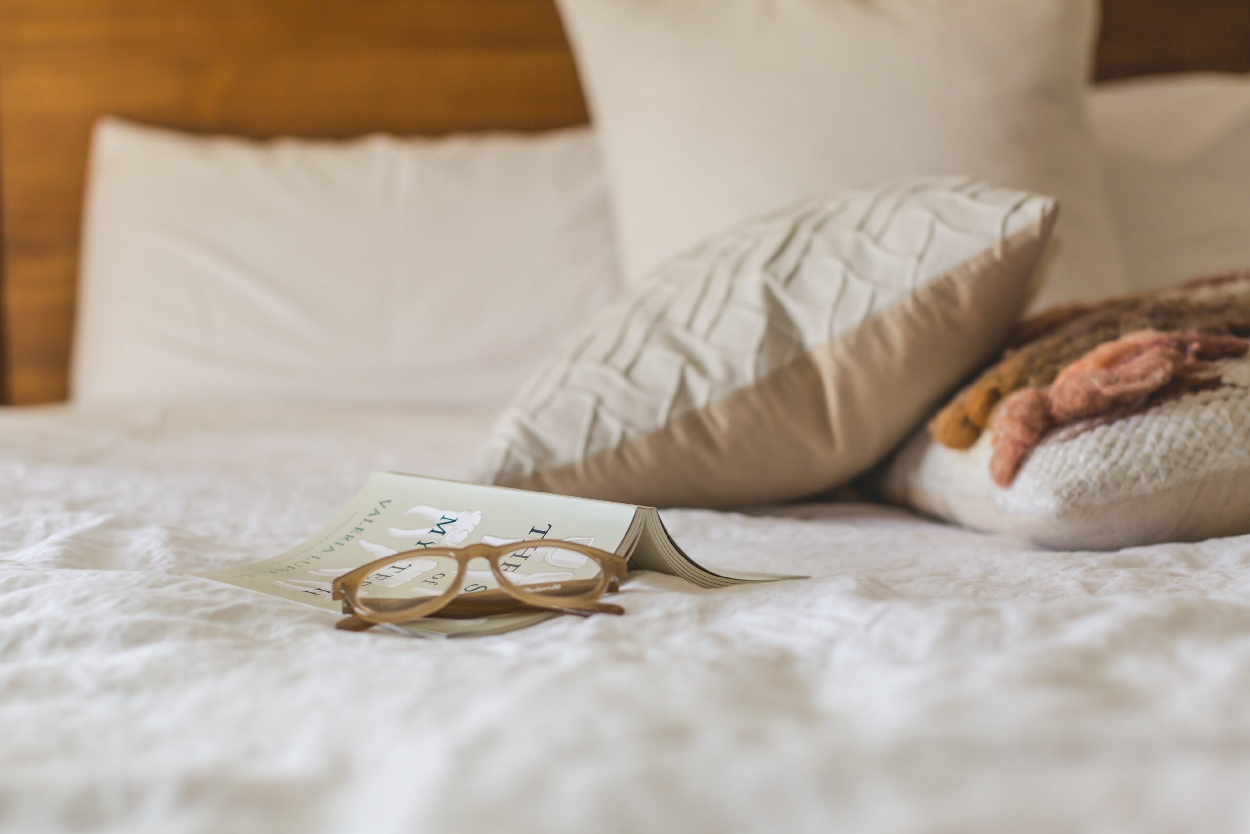 messy bed with glasses