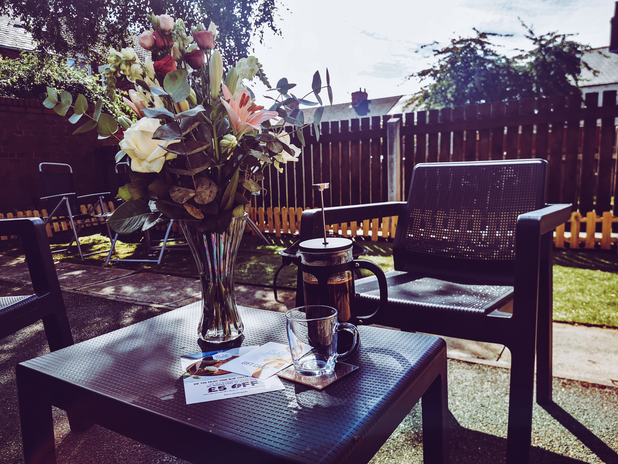 garden with flowers and coffee in a cafetiere on a table