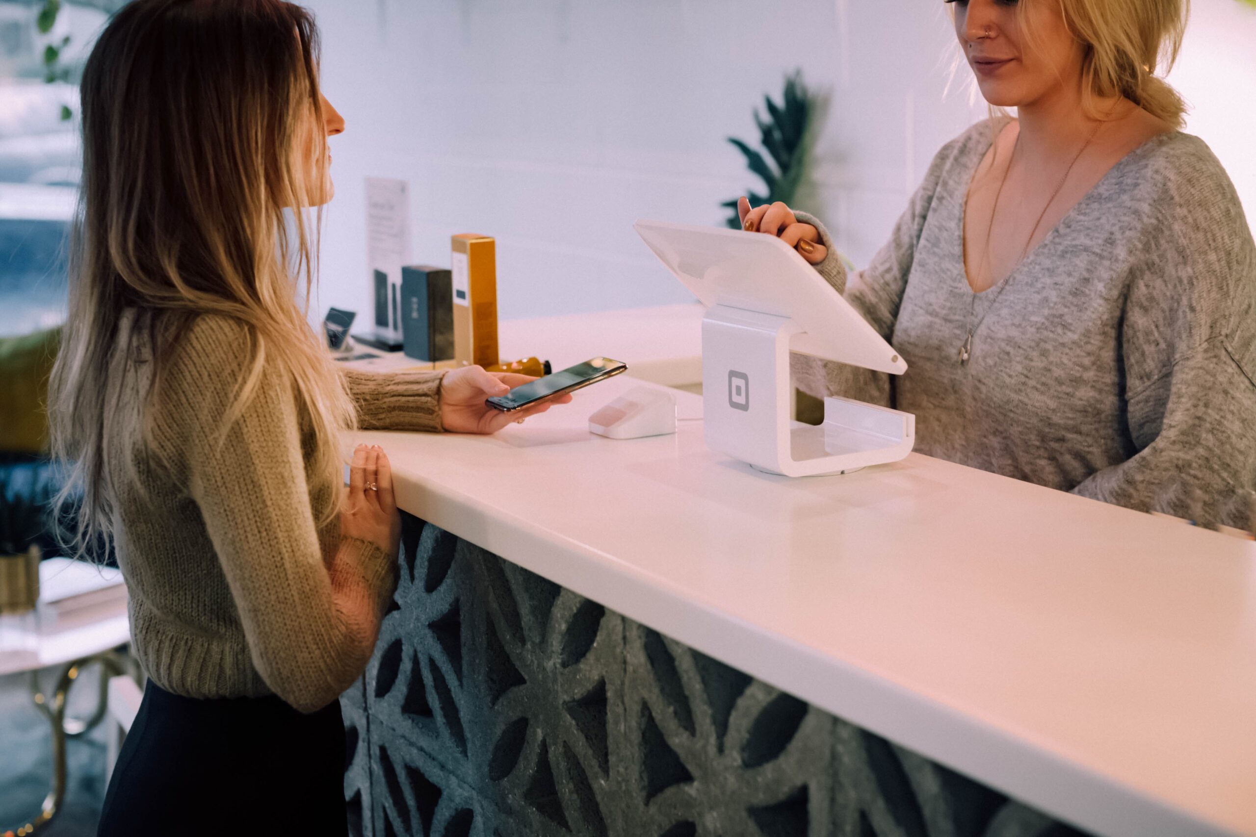 women standing around a shop counter