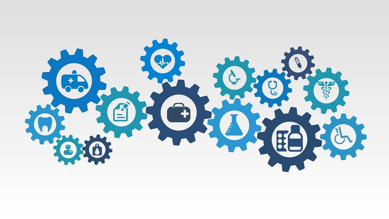 blue cogs on a whie background with medical symbols inside cogs