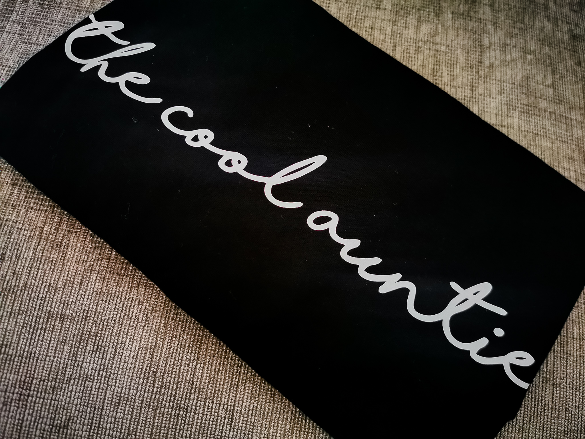 black tshirt with white words the cool auntie on them