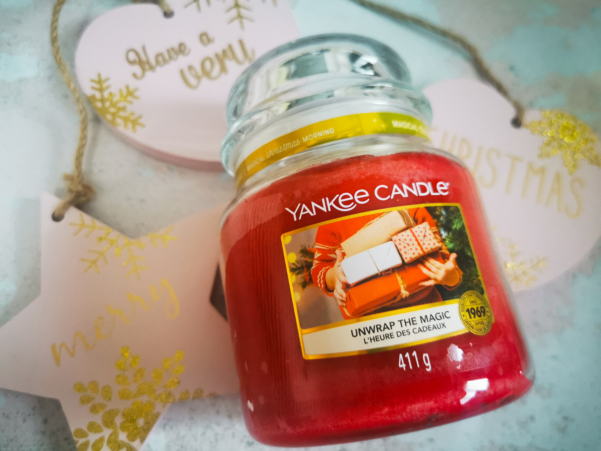 a red yankee candle in a christmas flatlay