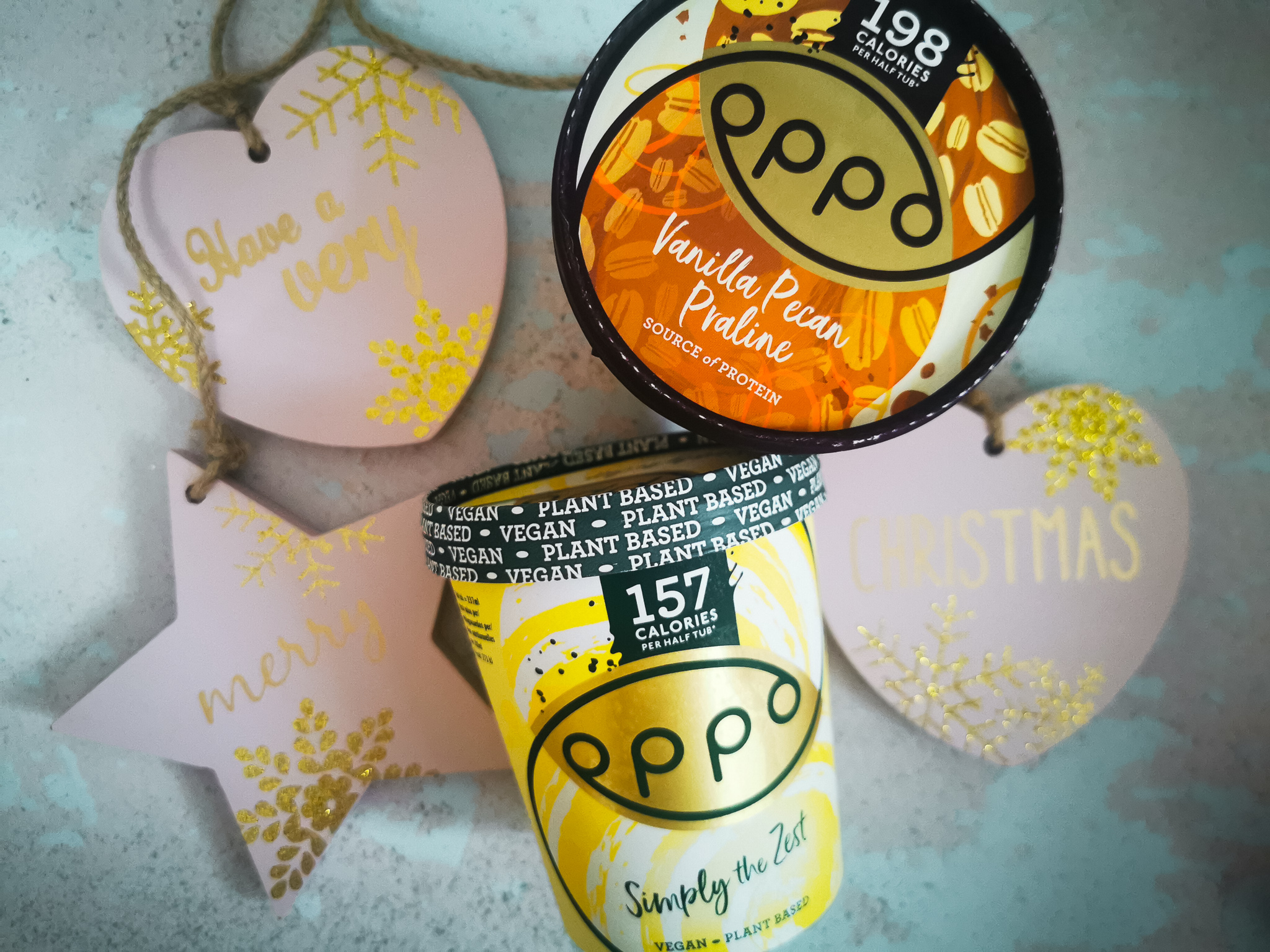 two tubs of oppo ice cream in a christmas flatlay
