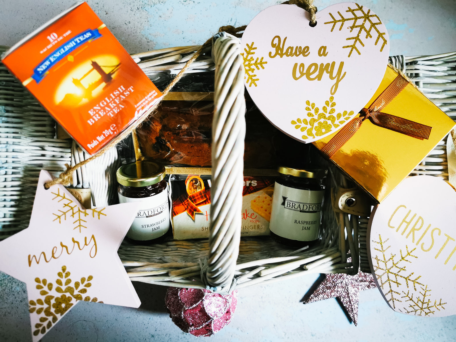 close up of a bradfords christmas gift hamper with christmas decorations around it