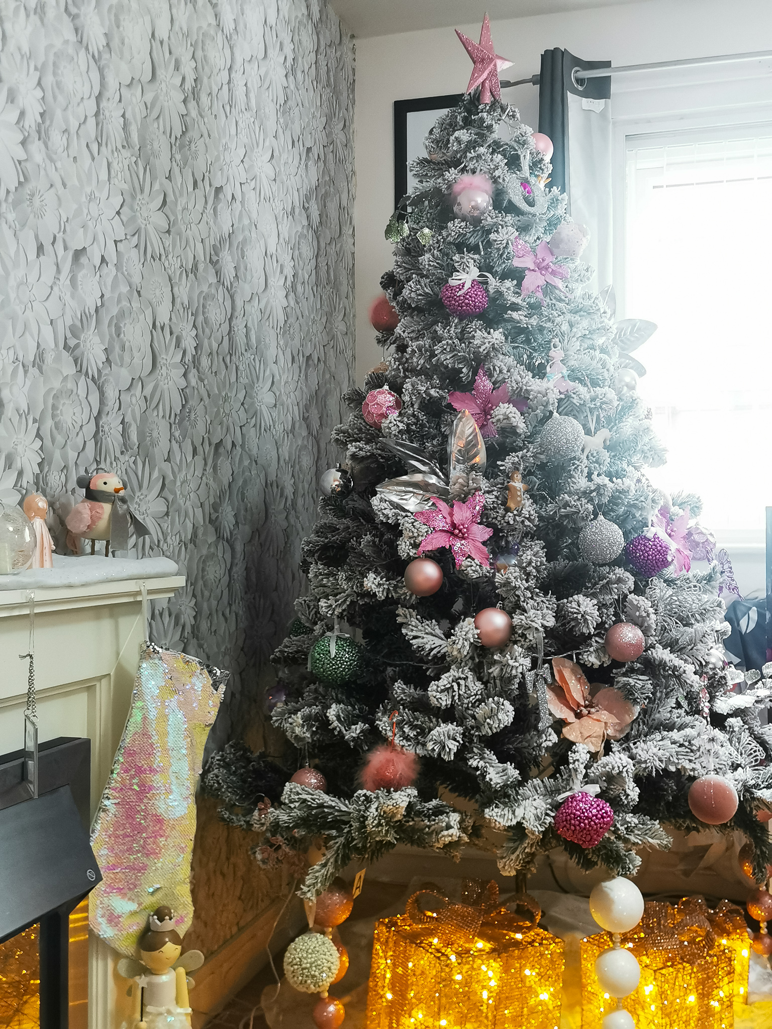 picture of a snowy christmas tree decorated with pastel decorations