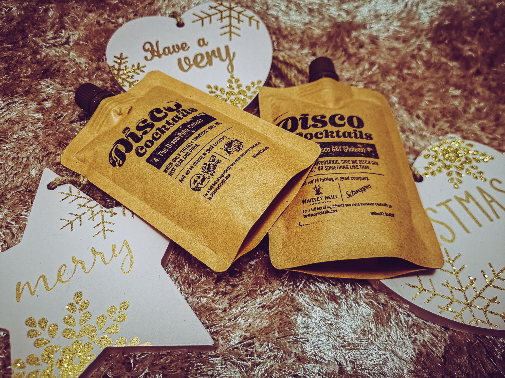 two pouches of disco cocktails in a xmas themed flatlay
