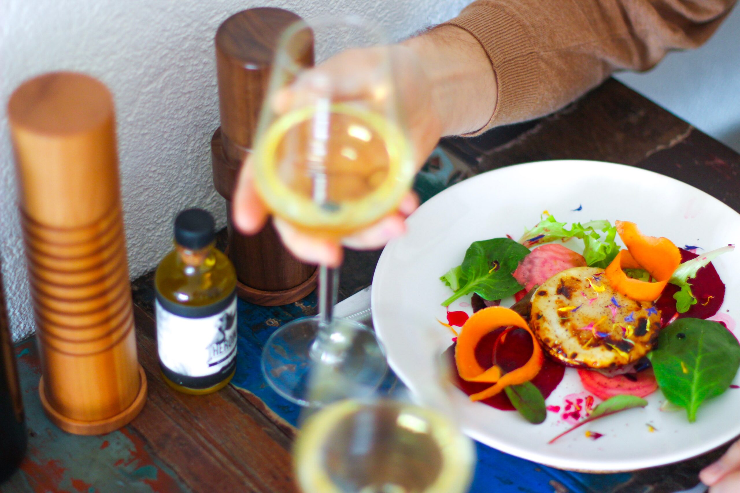 healthy meal on a plate with a glass of white wine