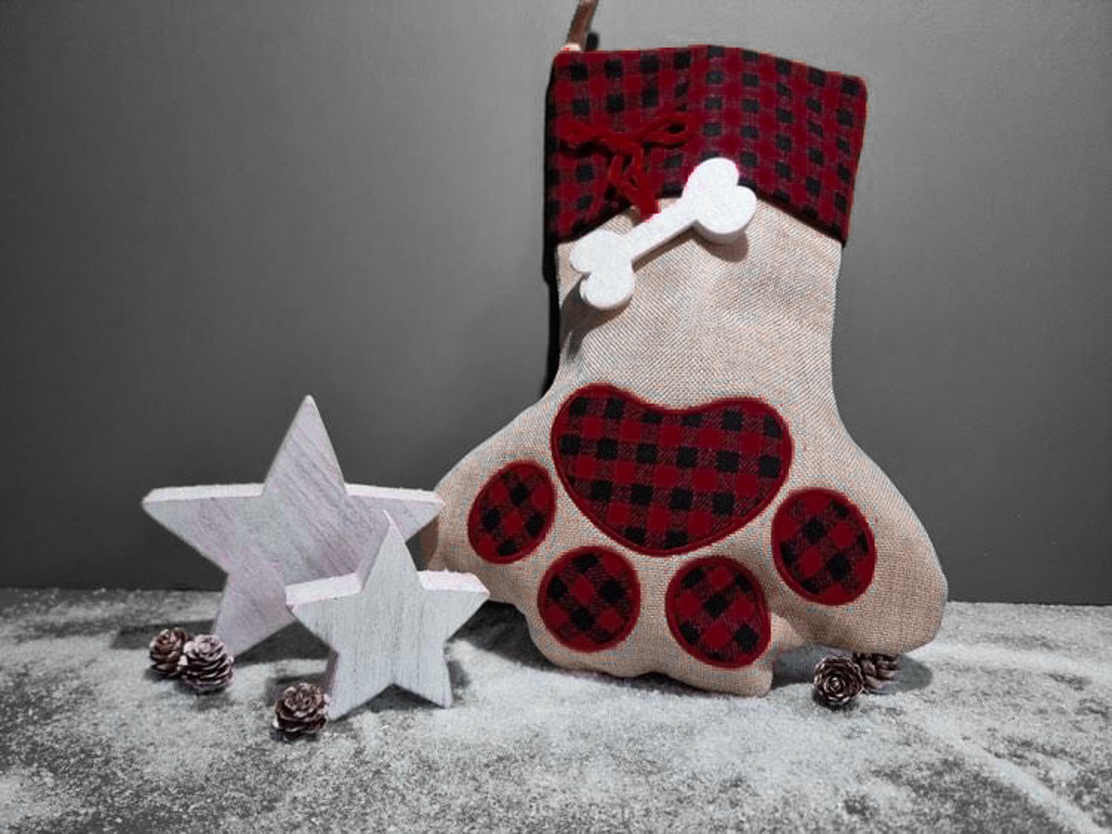 the stuffed hound's christmas pet stocking with two white wooden stars in front of it.