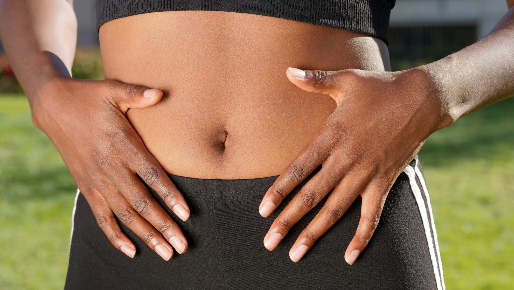 Midsection with hands on abdomen, illustrating gut awareness