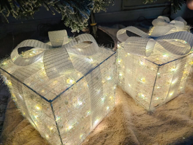 a view from above the quntis light-up present boxes in white when placed under a tree