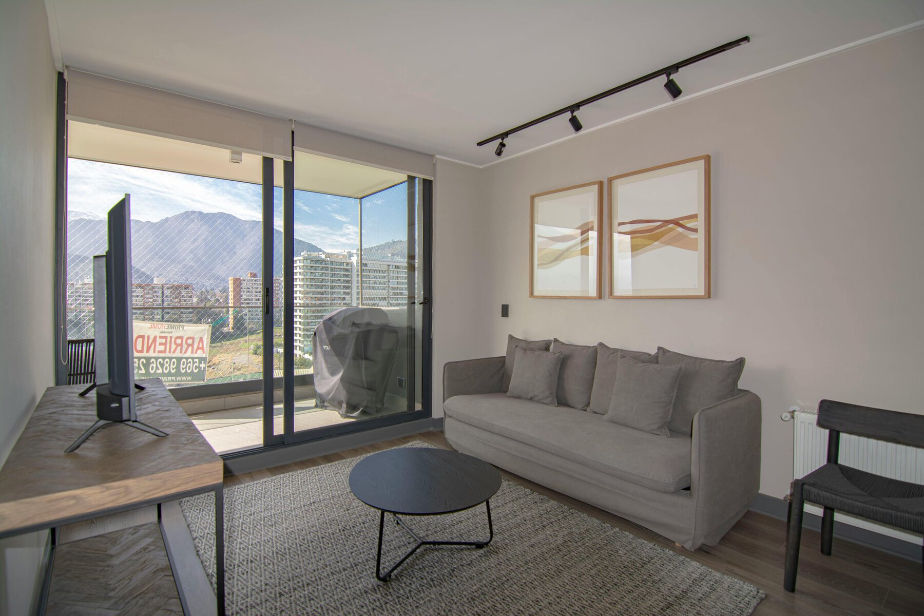 bright, modern living room with sofa, coffee table, and natural light streaming through windows
