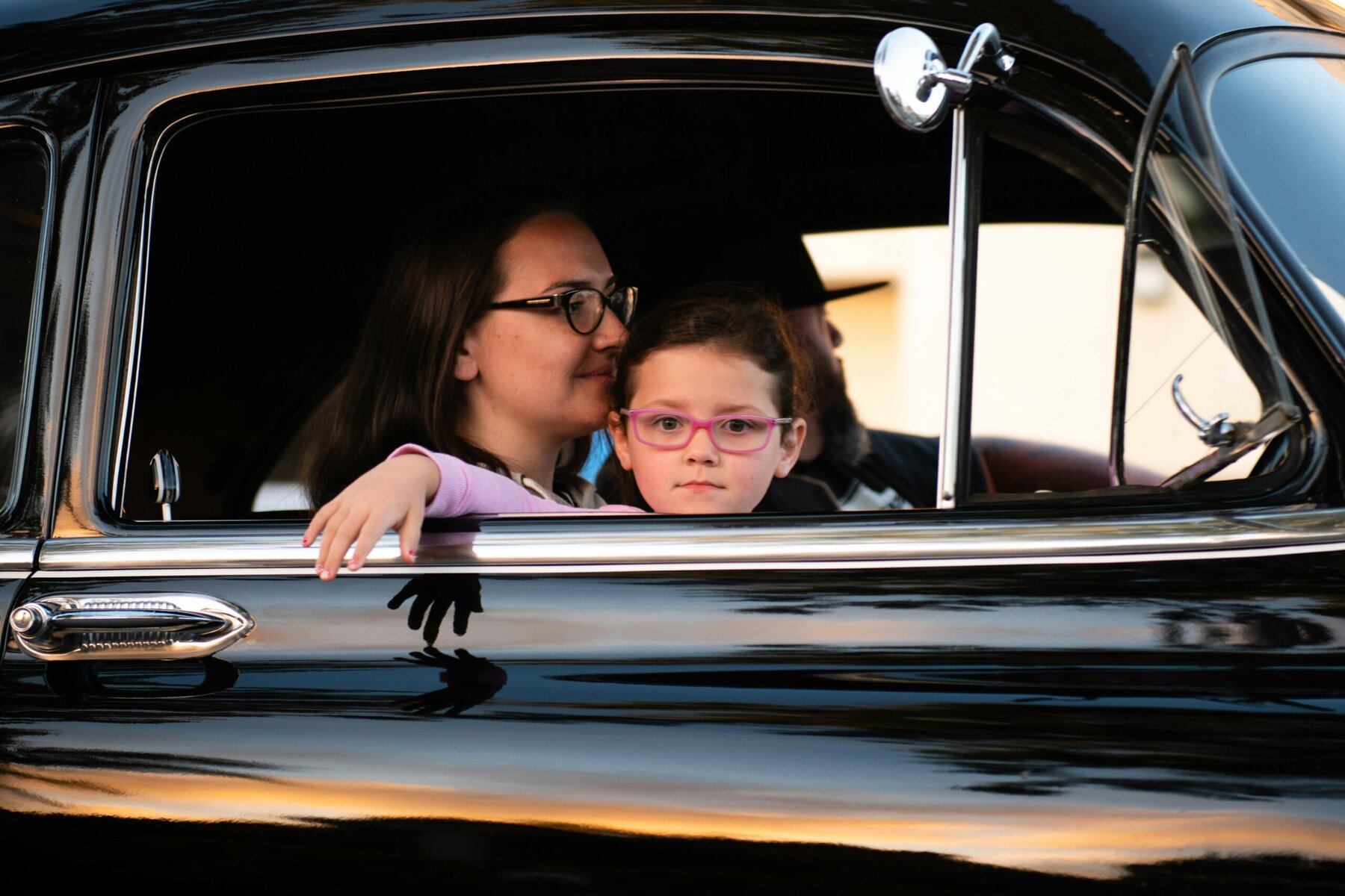 Mother and child sitting inside a car during a daytime drive, showing everyday family travel and car use