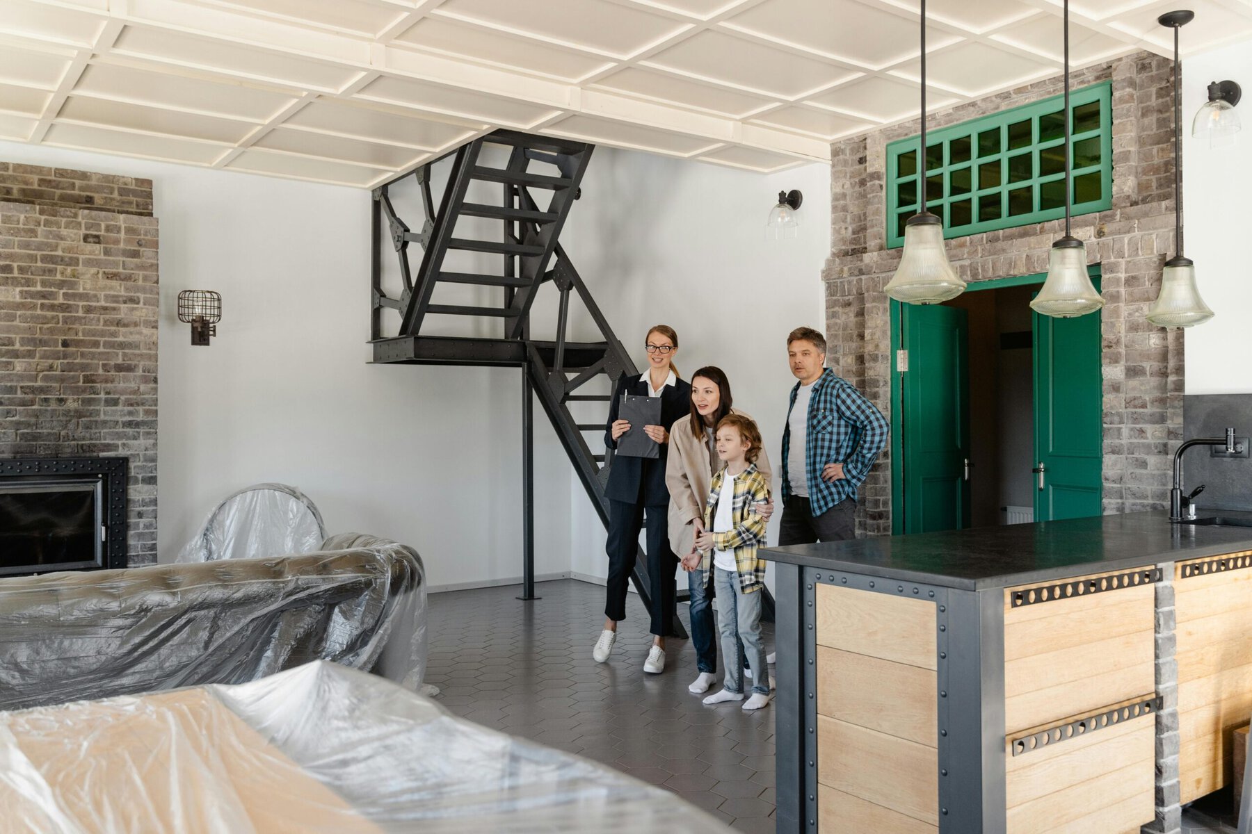 A smiling family standing together on a staircase inside a bright modern home