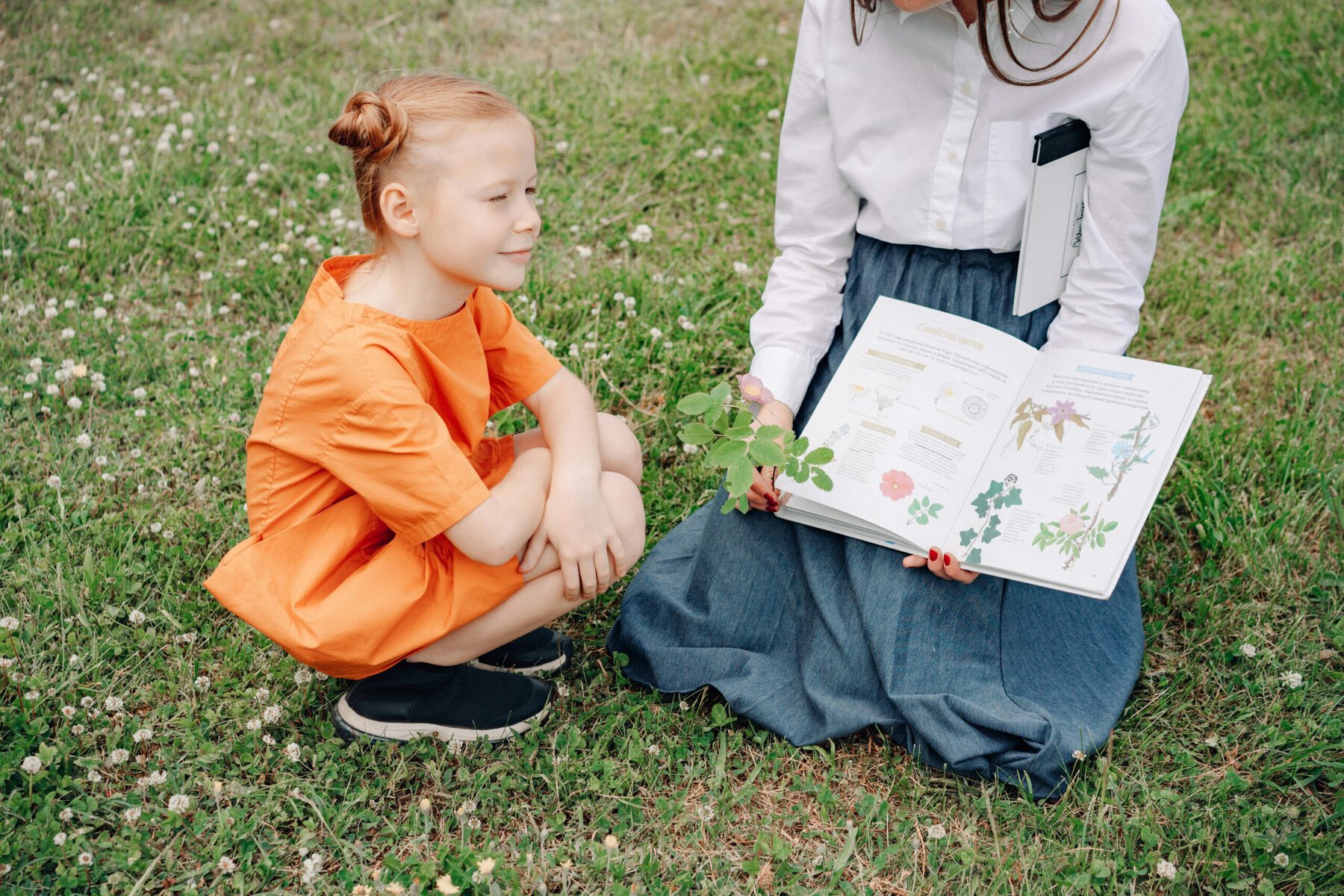 A young girl looking at a book