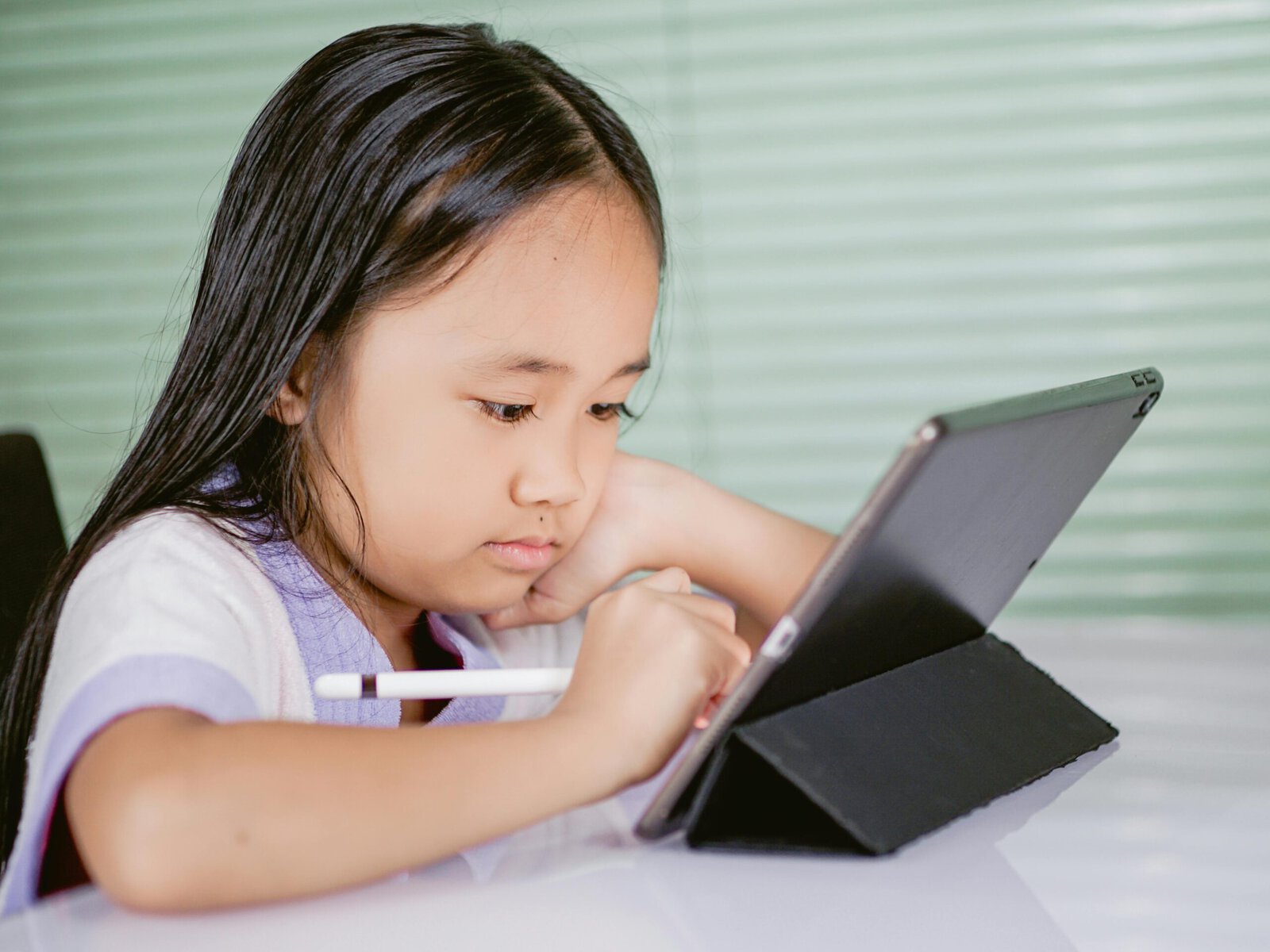 A girl using a tablet computer at home